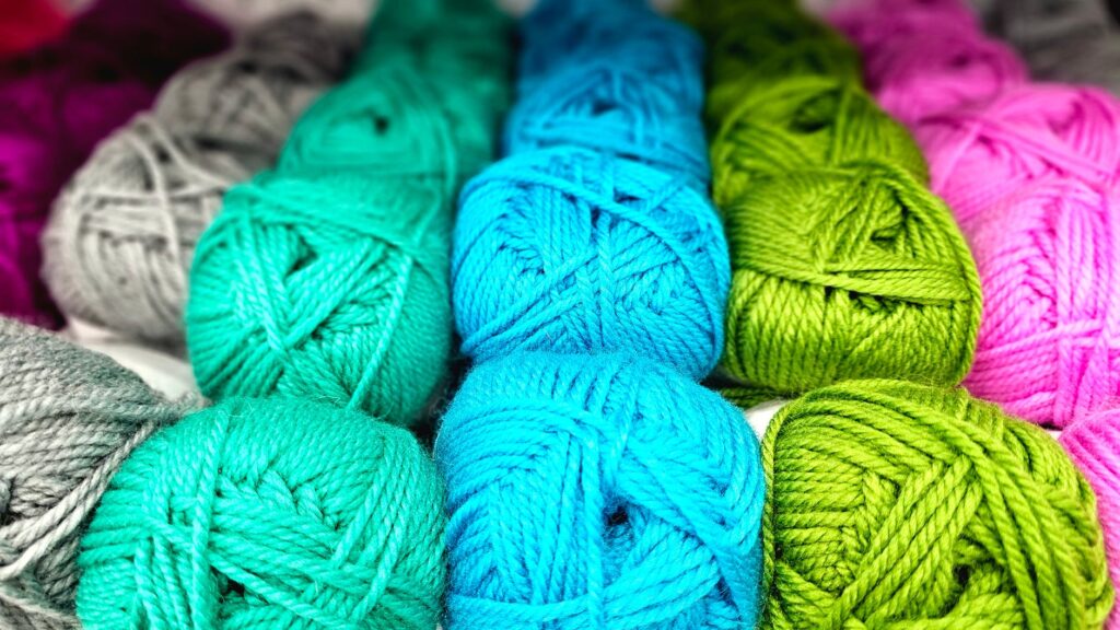 Vibrant yarn balls in various colors ideal for knitting and crochet.