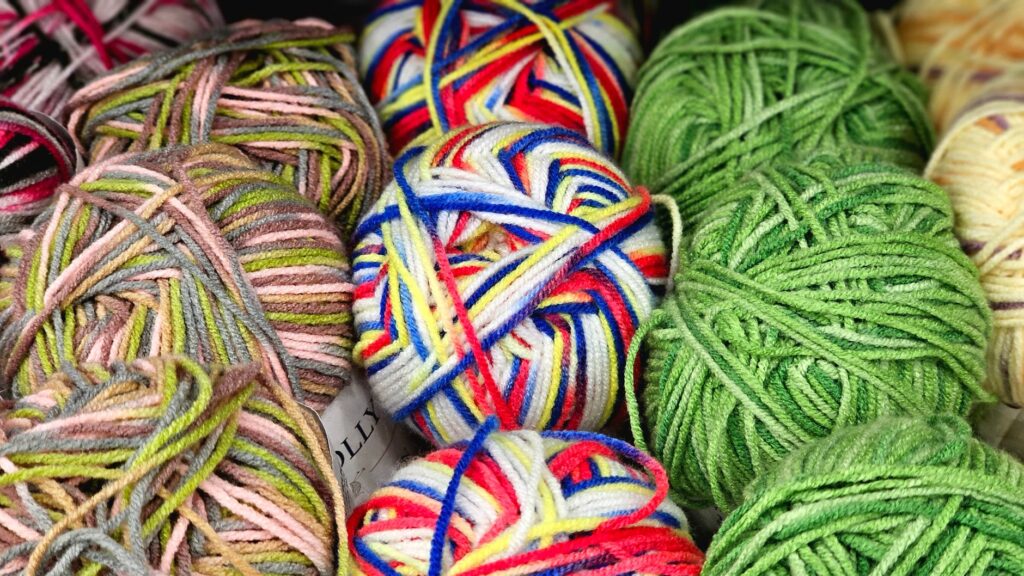 A vibrant collection of colorful yarn balls perfect for knitting and crafts.