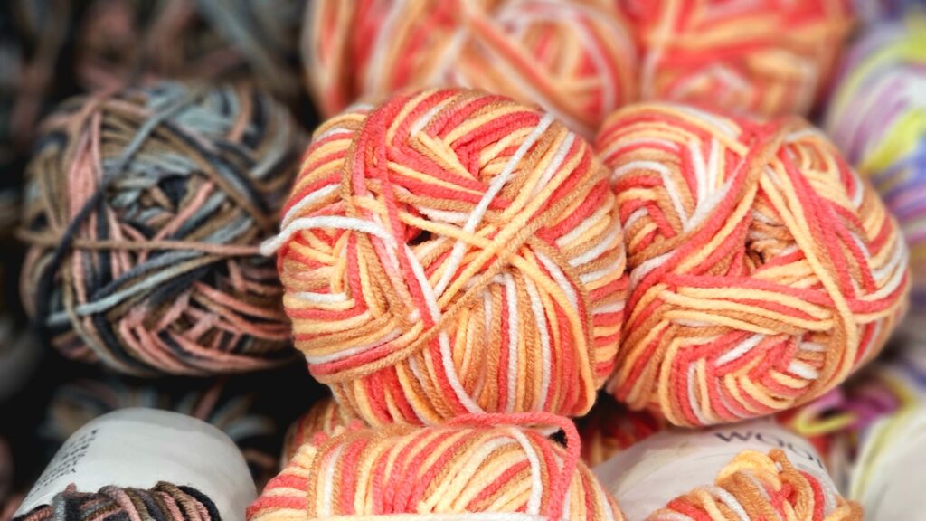 Vibrant multi-colored yarn balls perfect for knitting and crafting projects.