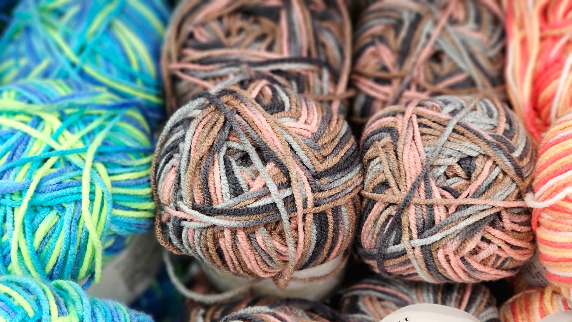 Close-up of colorful yarn balls showcasing vibrant patterns ideal for knitting and crocheting projects.