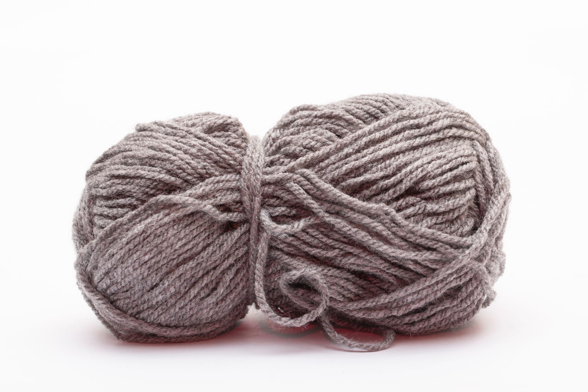 A detailed image of a grey yarn ball, perfect for knitting projects and crochet enthusiasts.