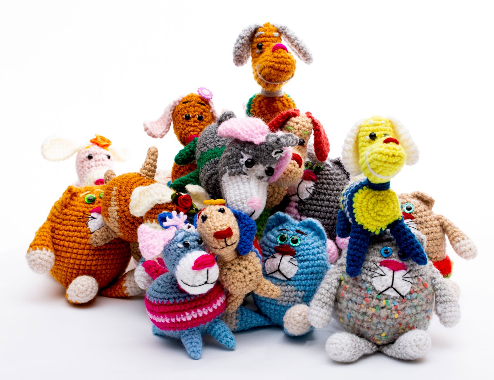 A vibrant collection of handmade crochet animal toys in various colors and designs.