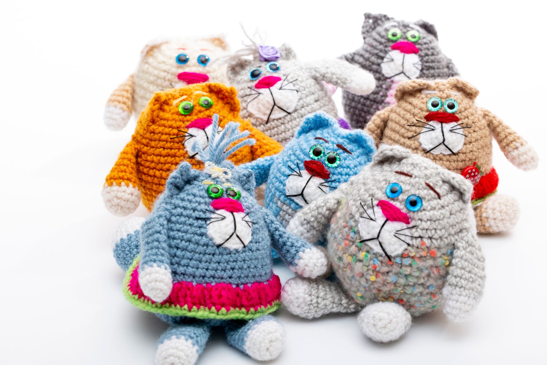 A playful and vibrant collection of handmade crochet cat toys in a variety of colors.