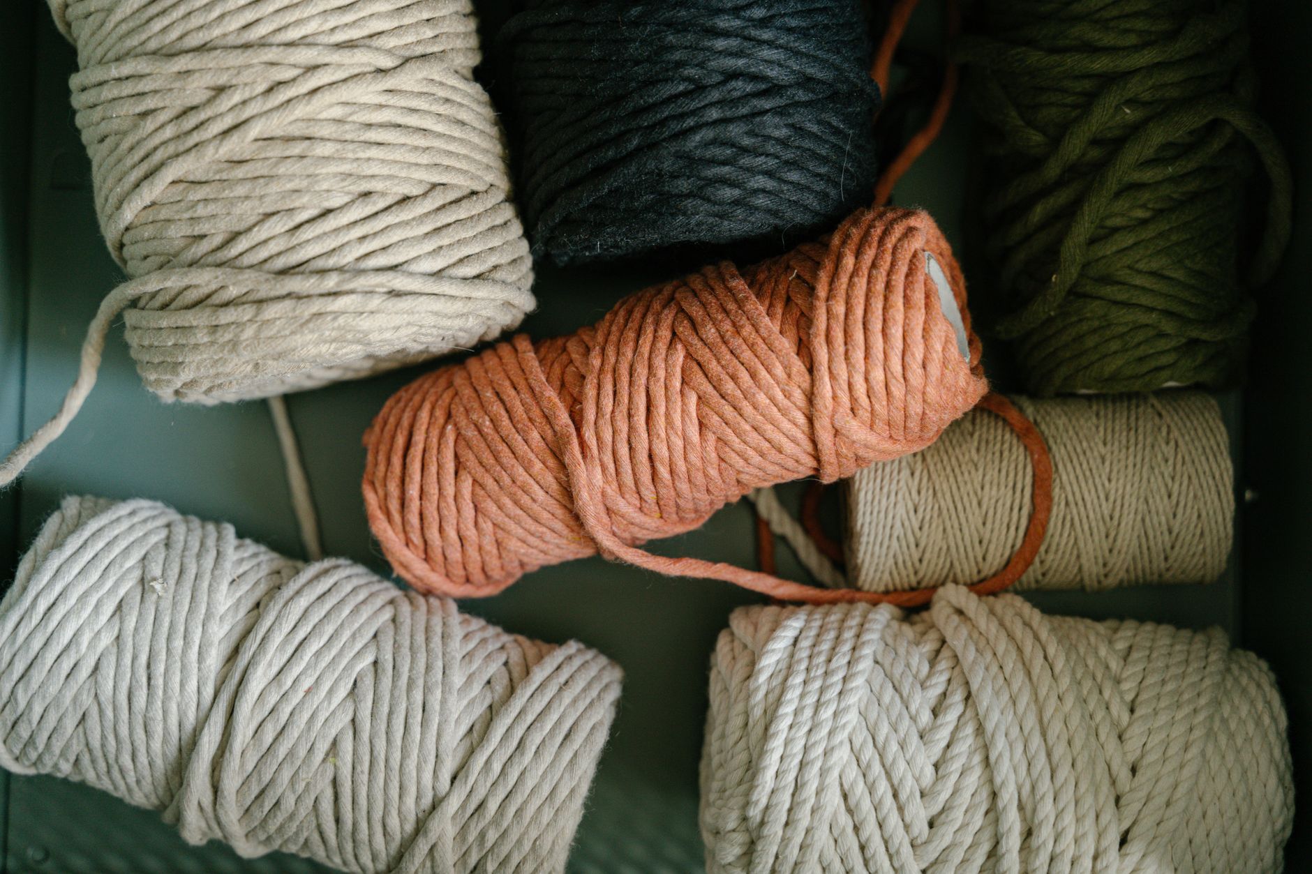 A high-angle view of various colorful yarn balls, ideal for knitting or embroidery crafts.