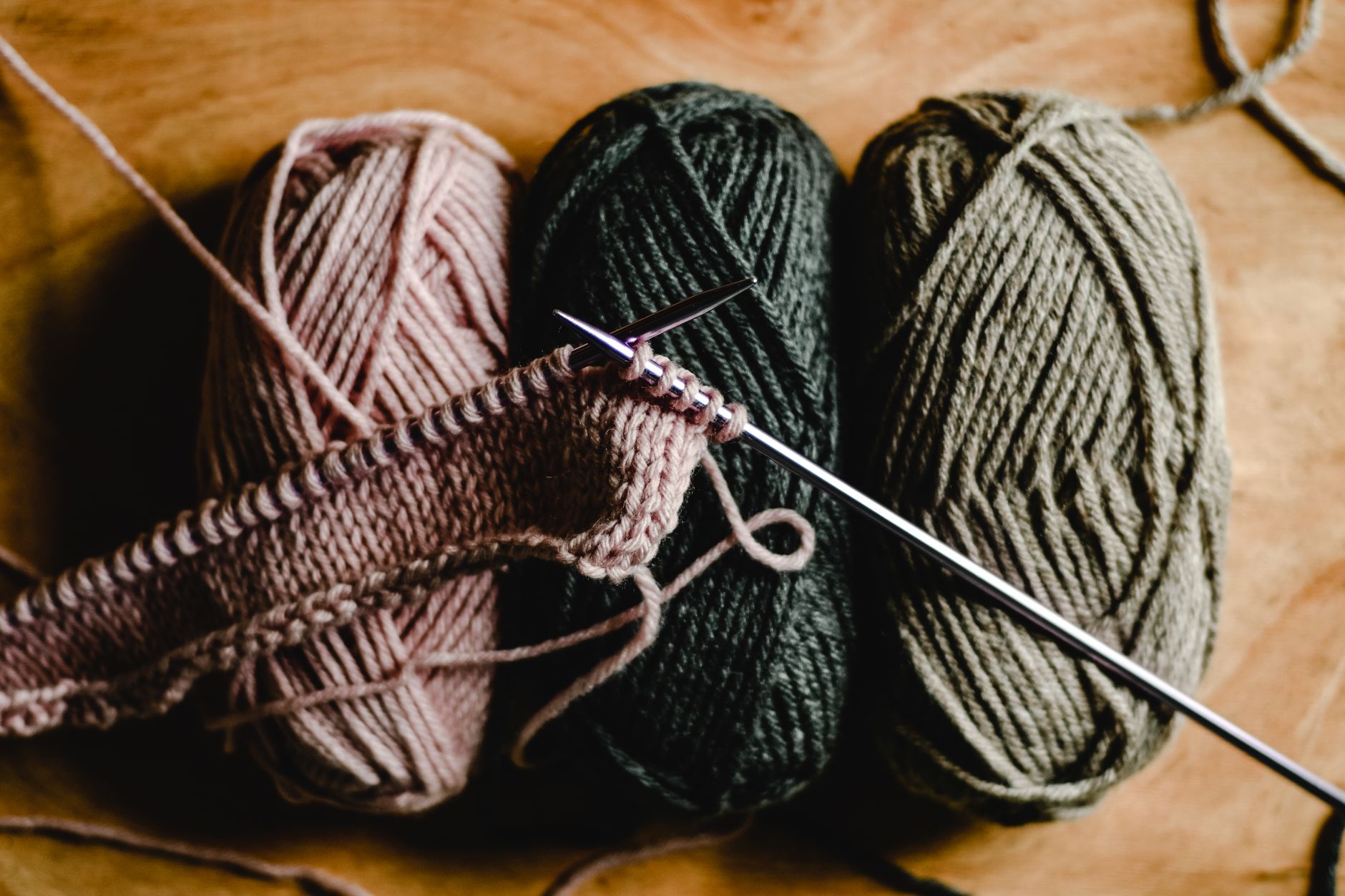 Close-up of vibrant yarn balls and knitting needles ready for DIY crafting.