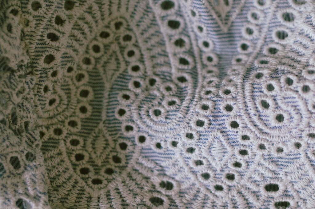 A detailed close-up of fabric highlighting beautiful lace patterns and textures.